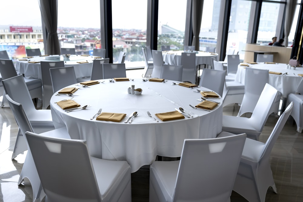 a table set up for a formal function with a view of the city