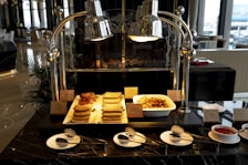 An inviting hotel dining area set for breakfast.
