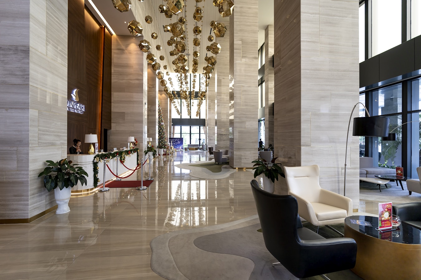 a hotel lobby with a chandelier hanging from the ceiling