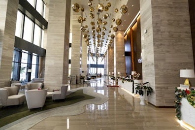 a hotel lobby with a chandelier hanging from the ceiling