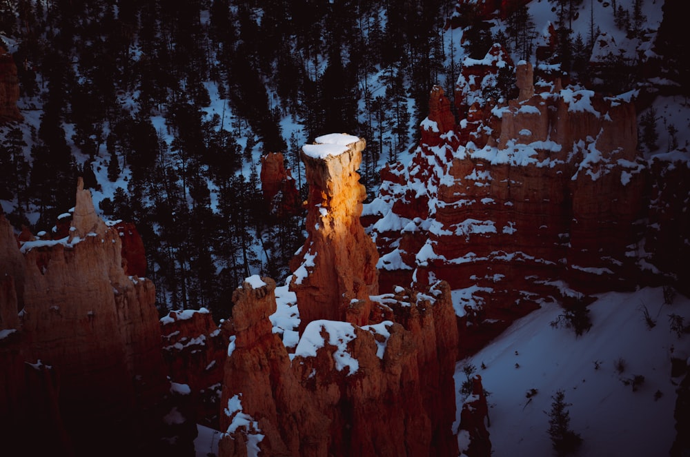 a light shines on a snow covered cliff