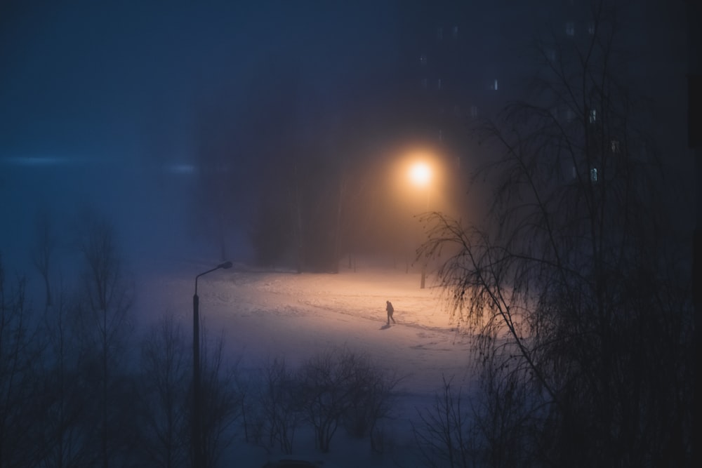 a person walking in the snow at night