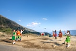 A group of children laughing together while practicing juggling with bright balls.
