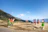 A joyful group of travelers playing traditional sports outdoors in the lush Sierra de Francia landscape.