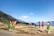 A joyful group of travelers playing traditional sports outdoors in the lush Sierra de Francia landscape.