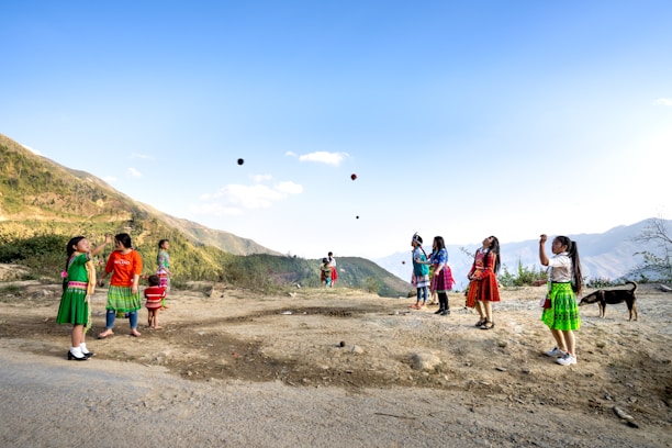 Smiling children wearing colorful casual clothes playing outdoors.