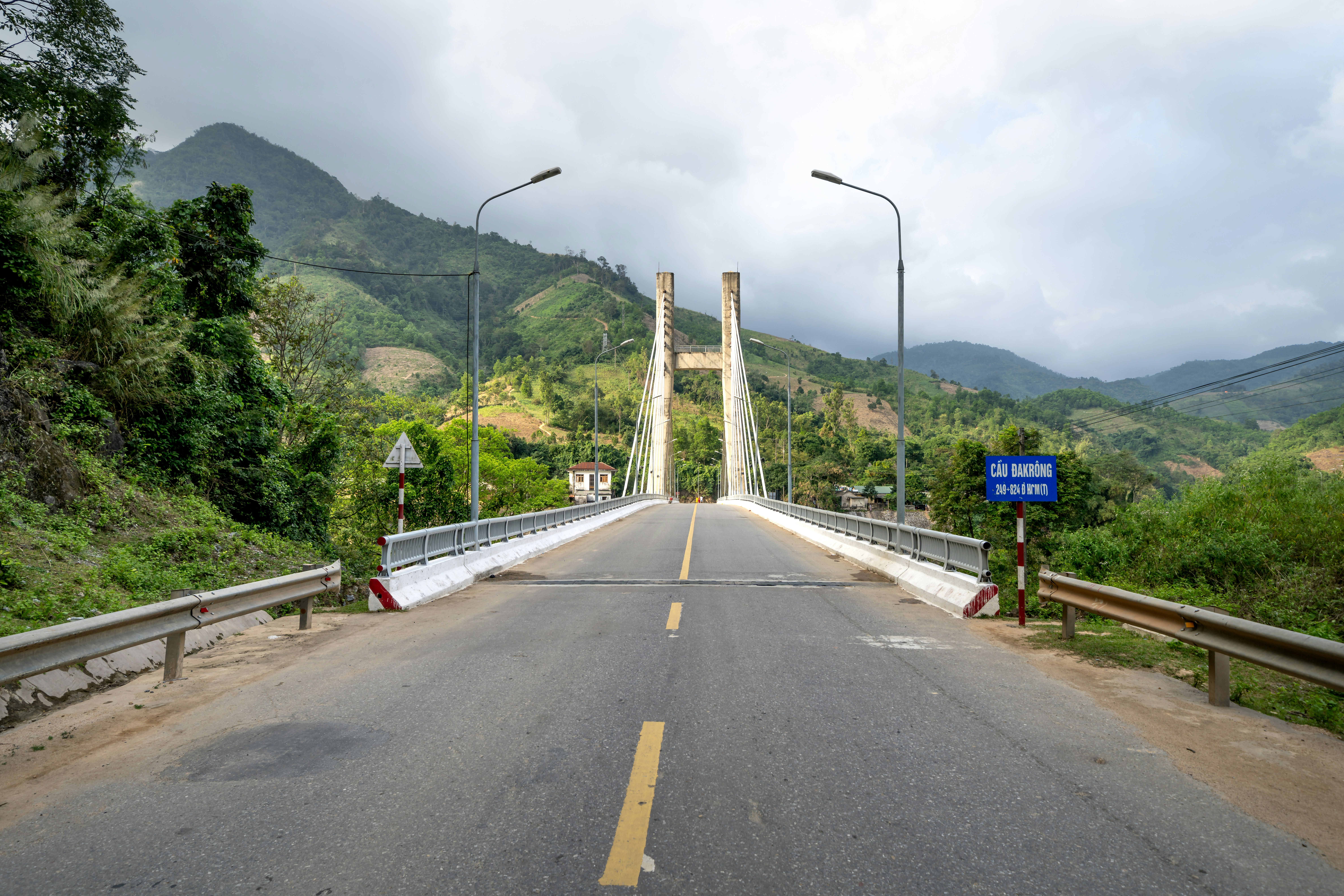 a long bridge with a sign on the side of it