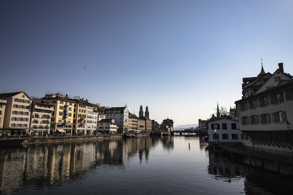 a river running through a city next to tall buildings