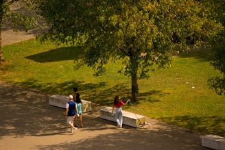 a couple of people walking down a sidewalk