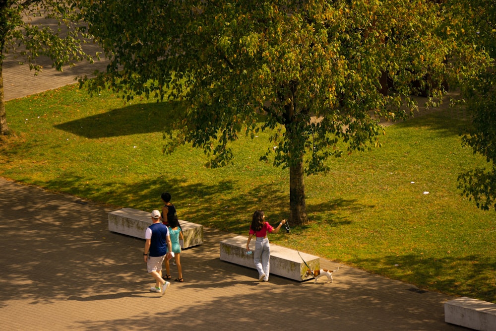 a couple of people walking down a sidewalk