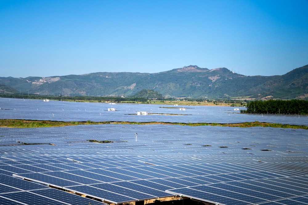 a large body of water with mountains in the background