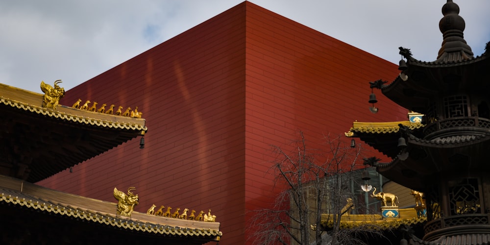 a red building with gold statues on top of it