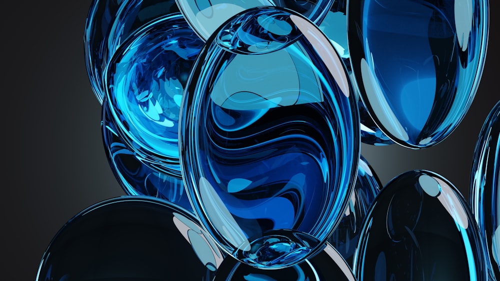 a group of blue glass balls on a black background