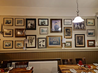 Elegant wooden picture frames holding family photos on a cozy living room wall.