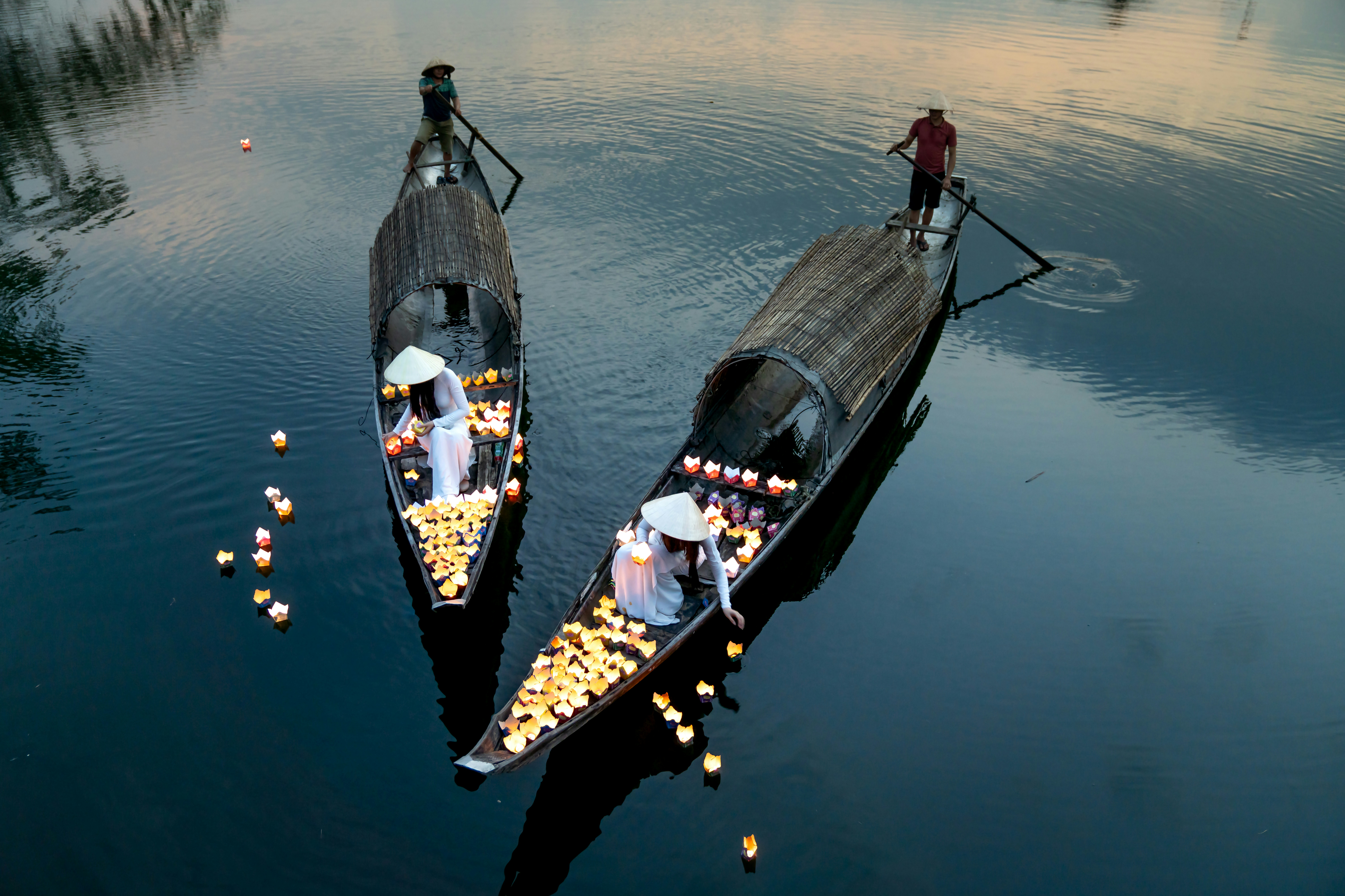 a couple of boats floating on top of a lake