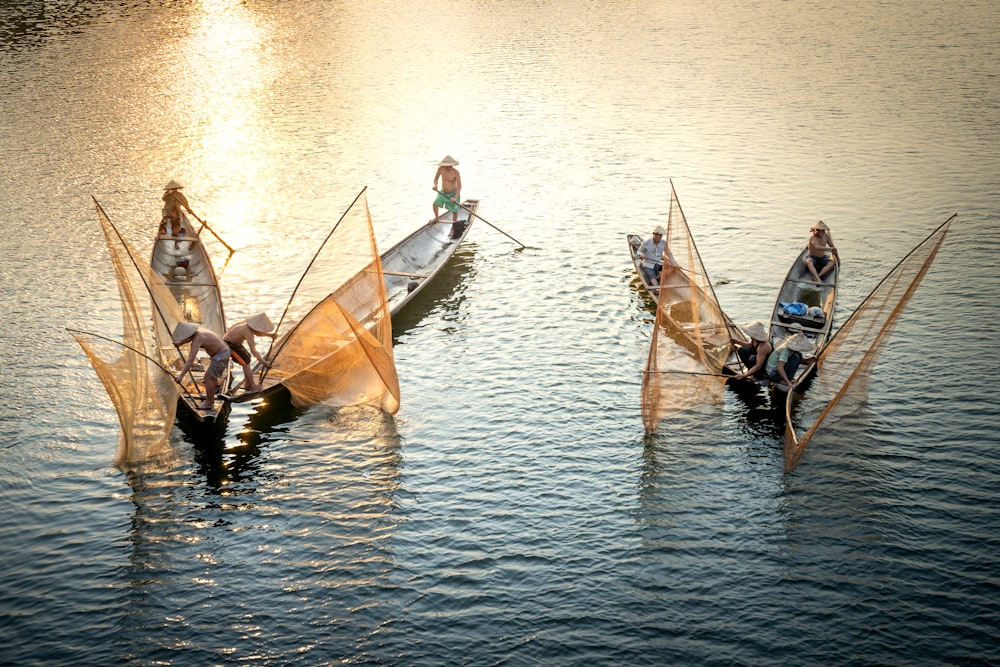 a group of people riding on top of boats in the water