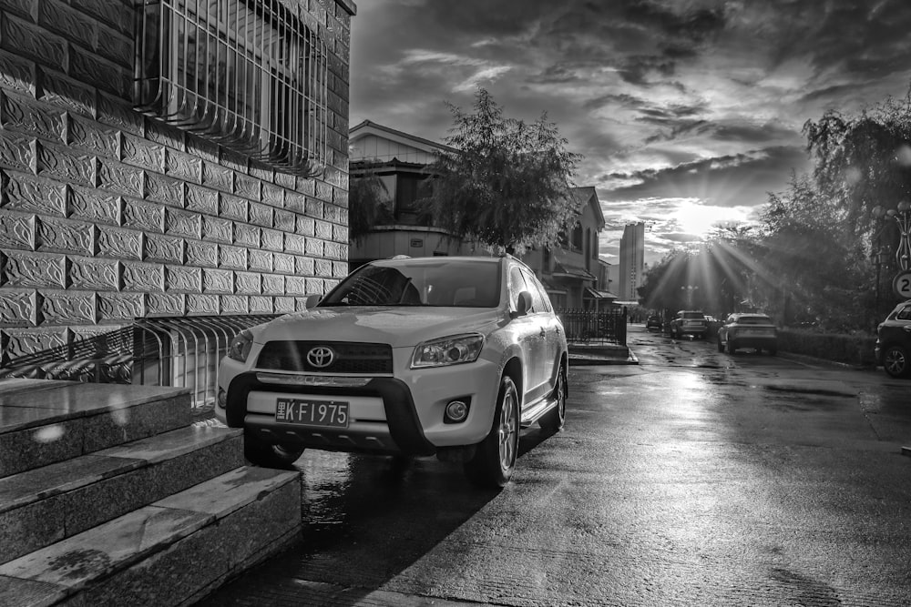 a white car parked on the side of a road