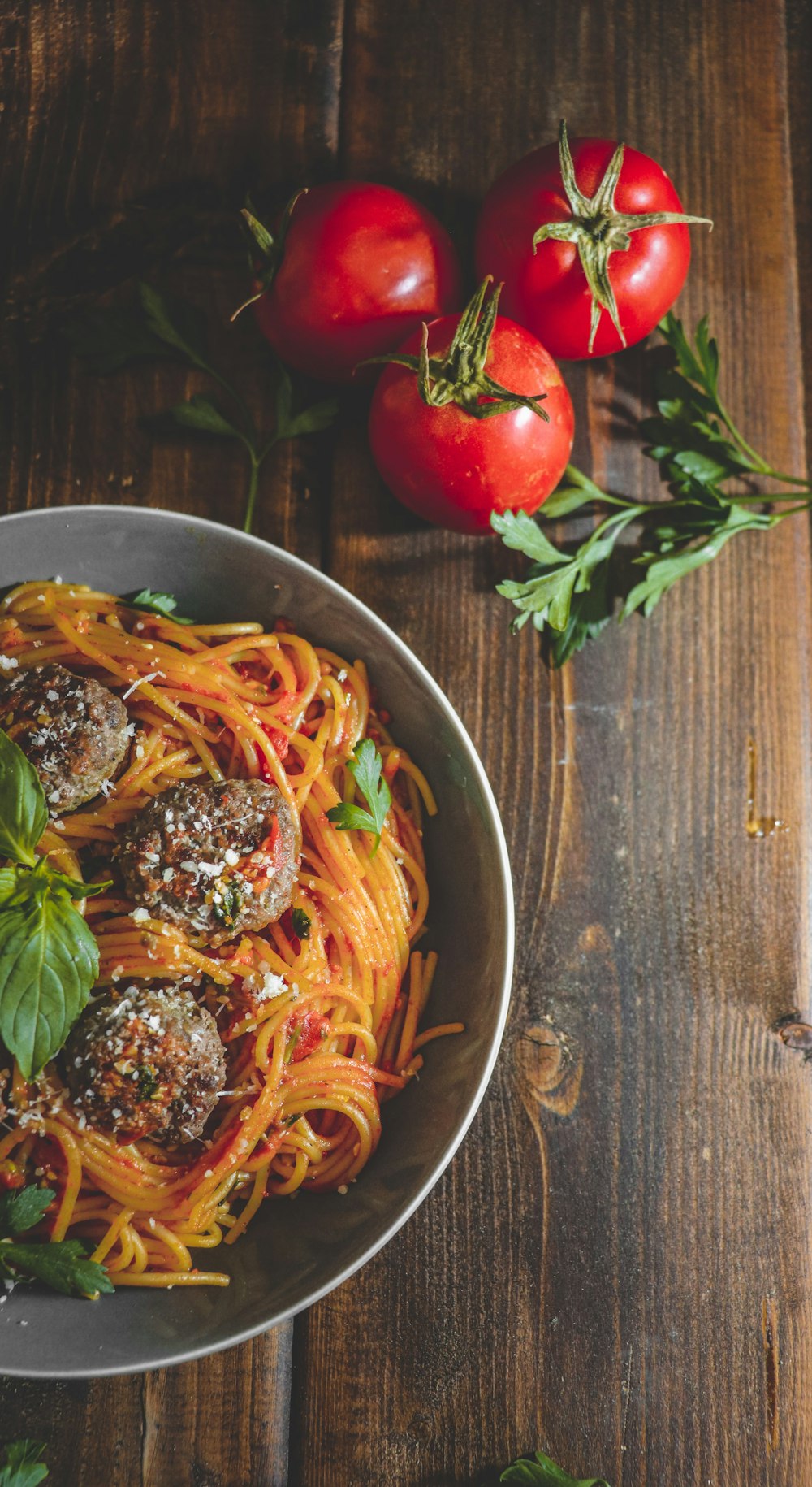 a bowl of spaghetti with meatballs and tomatoes