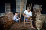 A child carefully assembling a wooden birdhouse during a workshop.