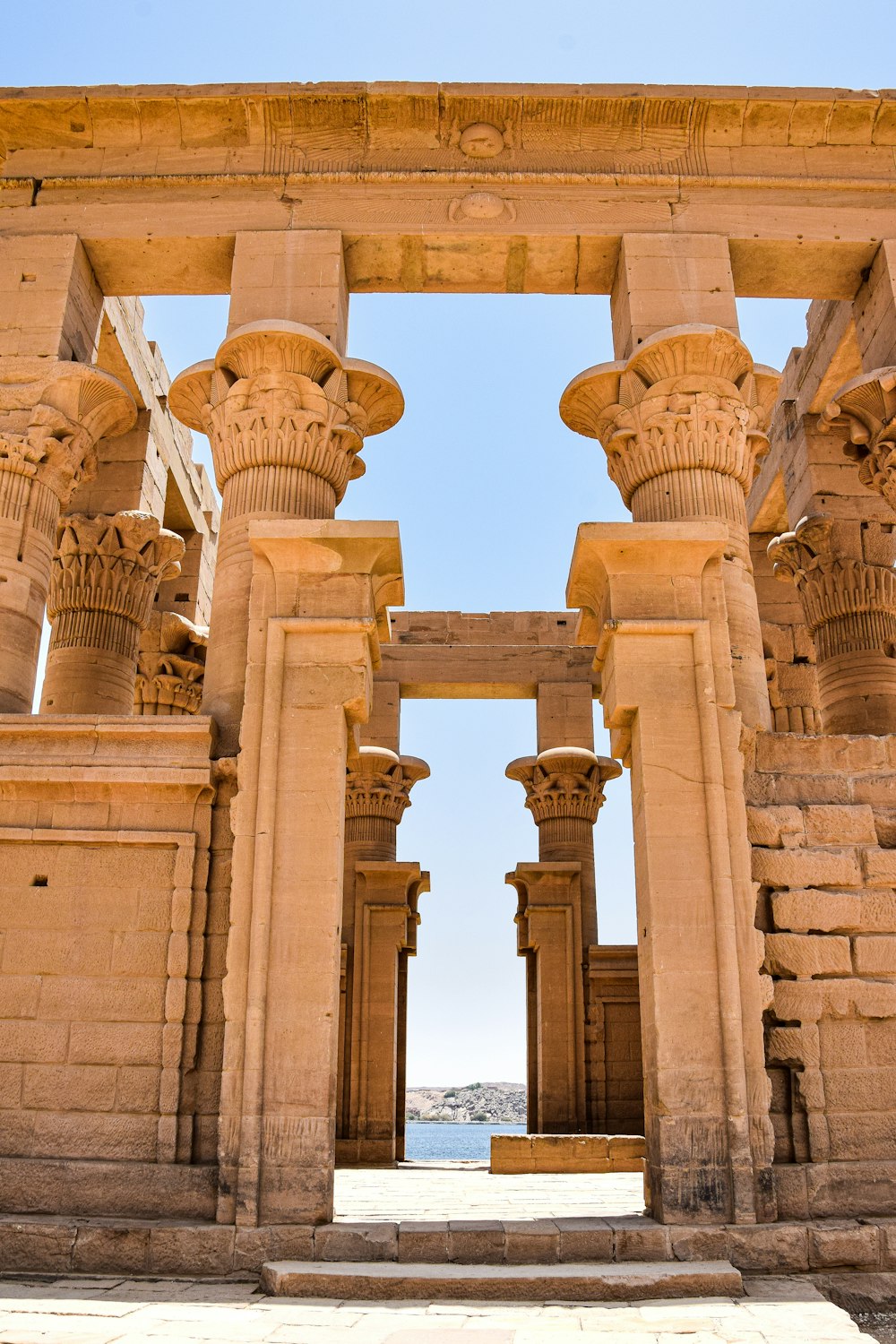 a large stone structure with columns and a sky background