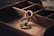 A gold ring with an intricate design featuring overlapping circular patterns lies in a wooden compartmentalized box. The background includes a few pieces of vintage paper, adding a rustic and historical ambiance.