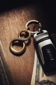 Close-up of a rental car key and contract on a clean wooden table.