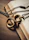 A close-up of broken chains lying on an open Bible with a bronze cross nearby.