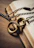 A close-up of broken chains lying on an open Bible with a bronze cross nearby.