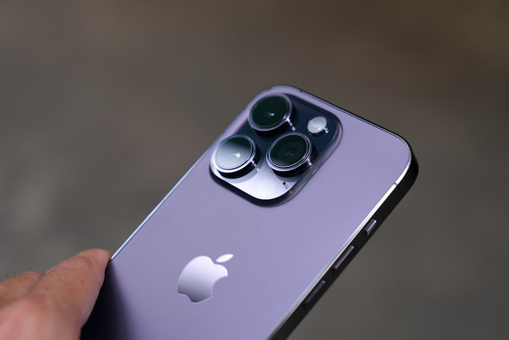 a close up of a person holding an iphone
