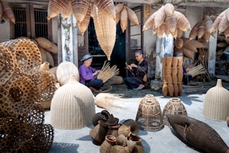 a woman sitting on the ground surrounded by baskets