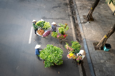 a group of people walking down a street next to a street