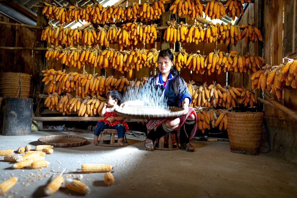 a man sitting at a table in front of a bunch of bananas