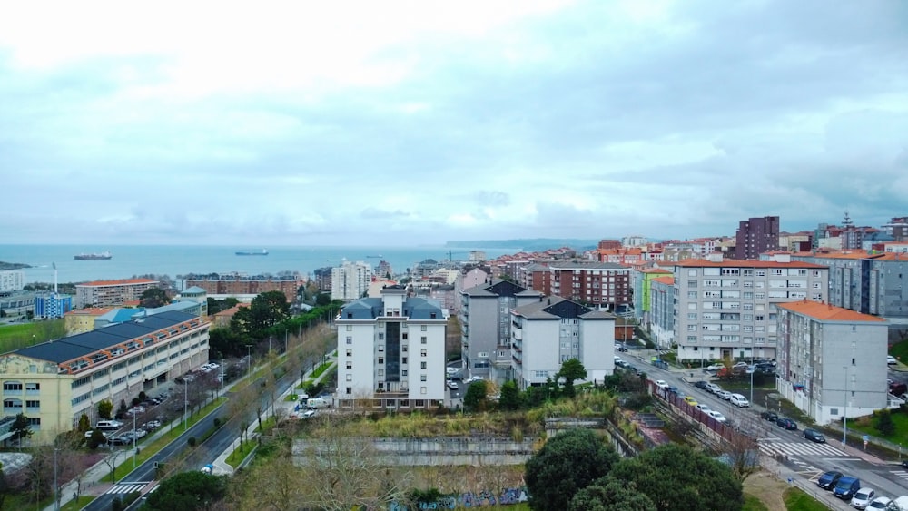 an aerial view of a city with buildings and a body of water