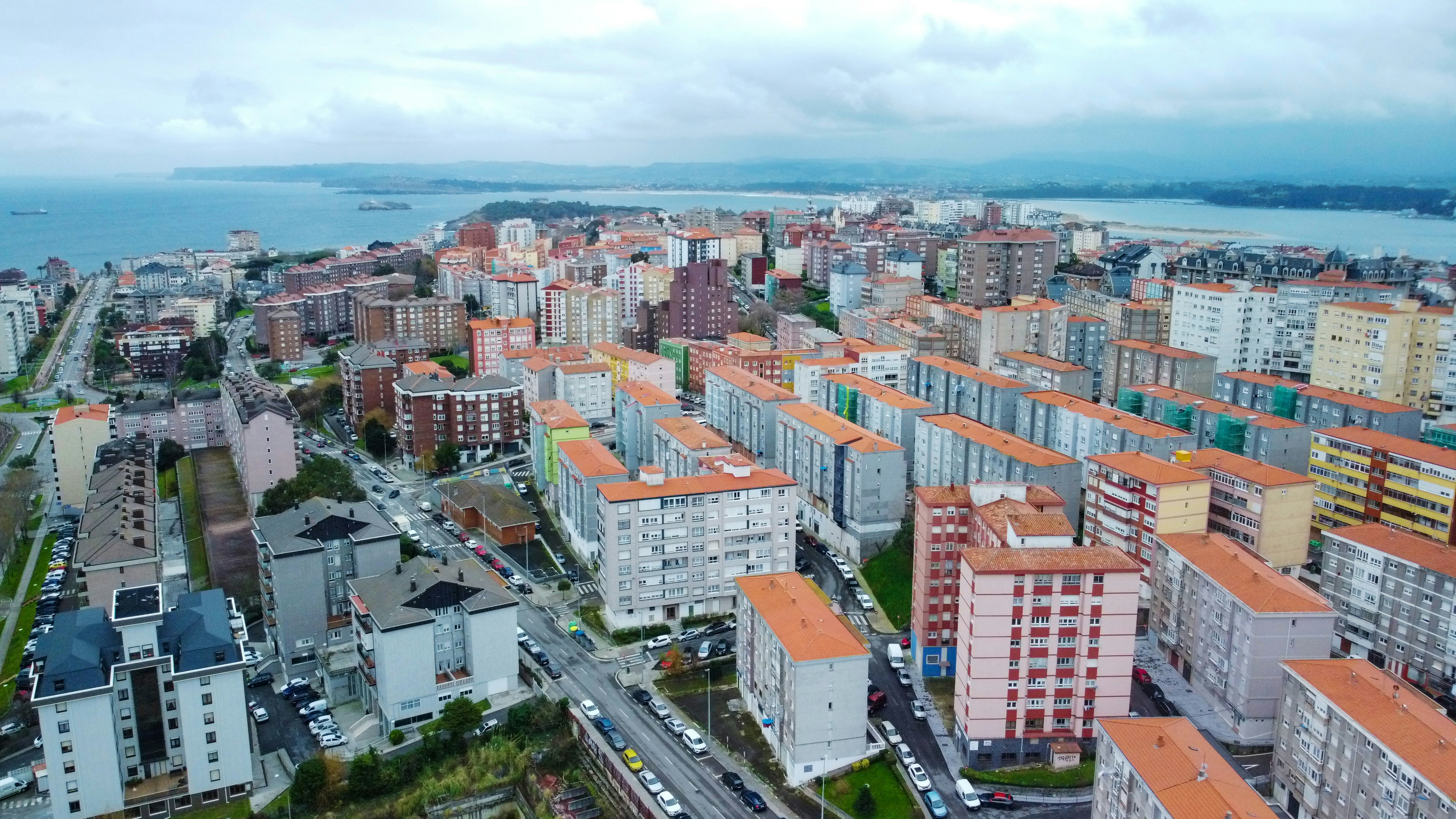 a city with lots of tall buildings next to a body of water
