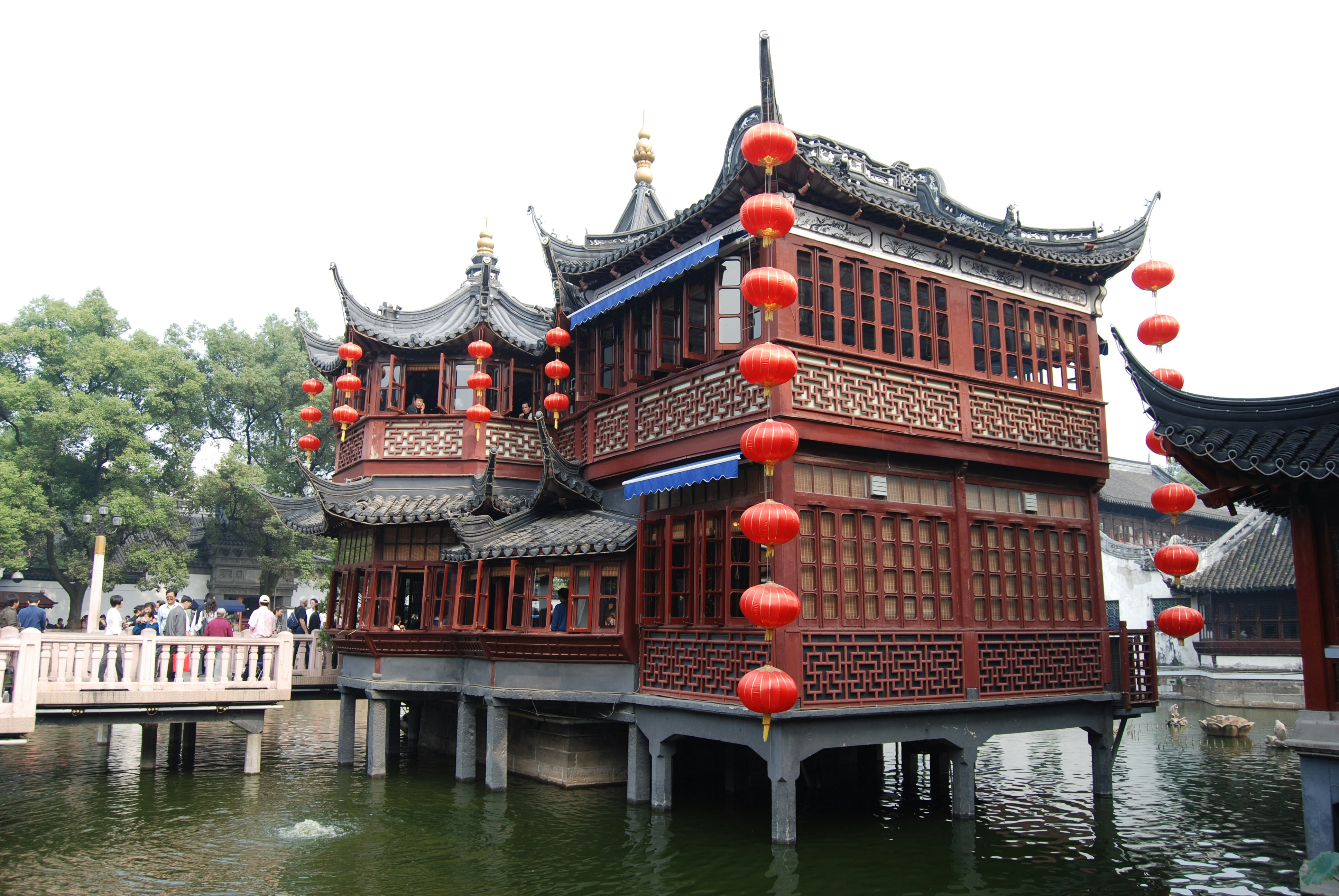a building with red lanterns hanging from it's roof