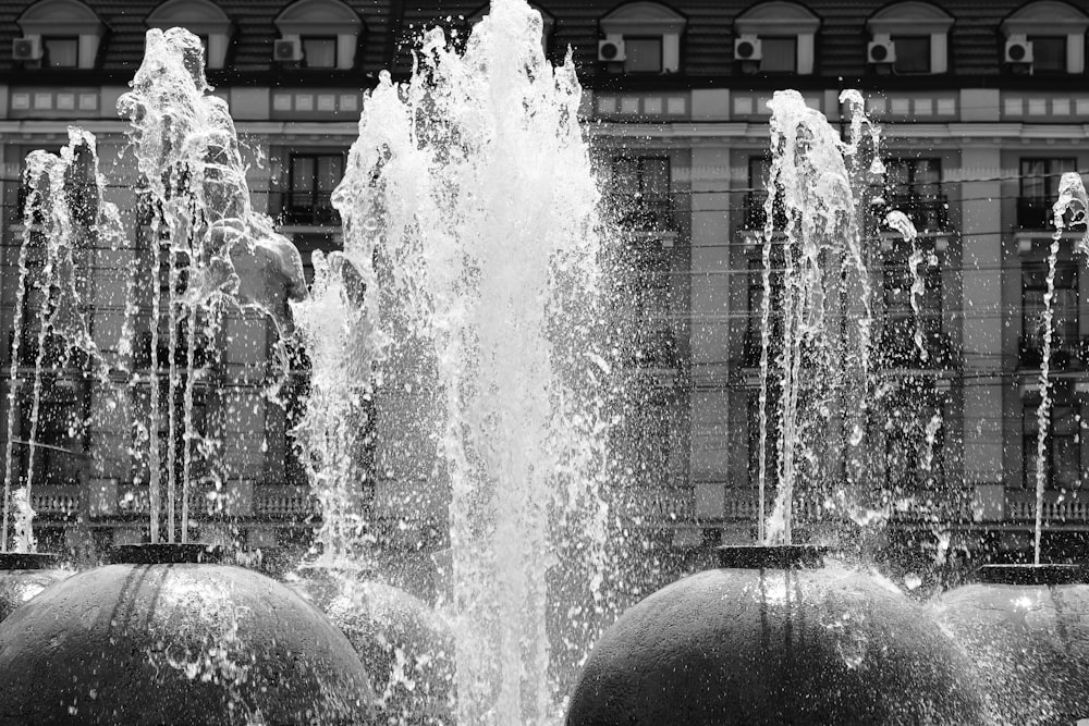 a black and white photo of a water fountain