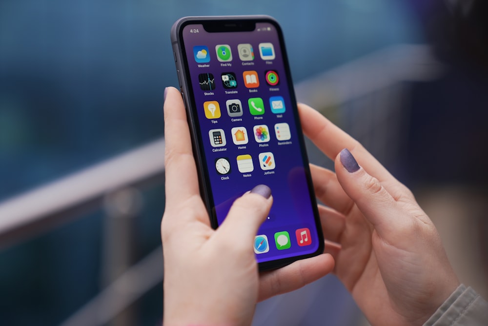 a woman holding a cell phone in her hands