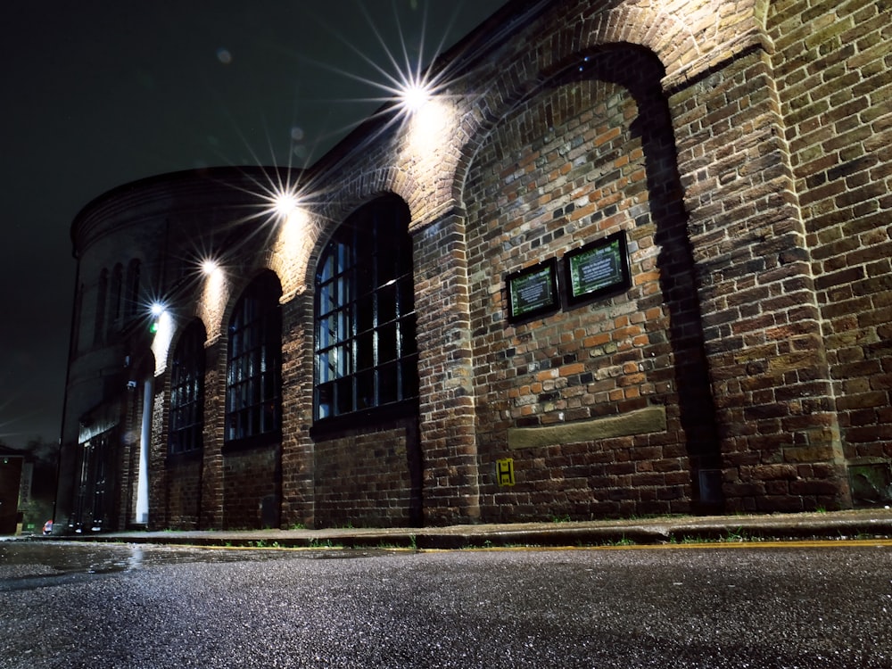 a brick building lit up at night with street lights