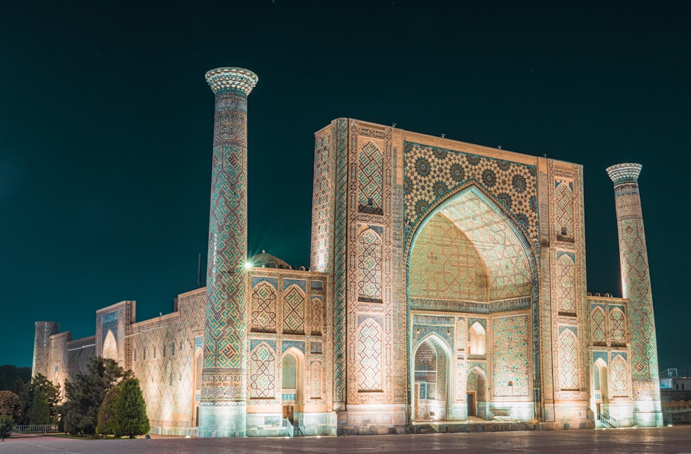 a large building lit up at night with lights