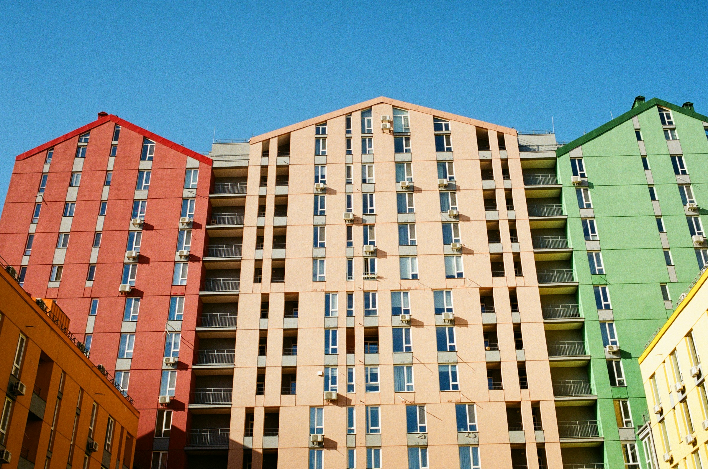 Modern British apartment buildings against blue sky