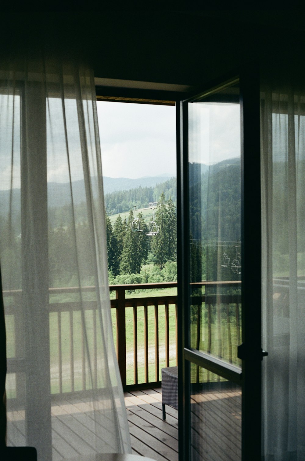 a bedroom with a balcony and a view of the mountains