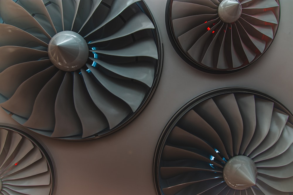 a group of three jet engines mounted to the side of a wall