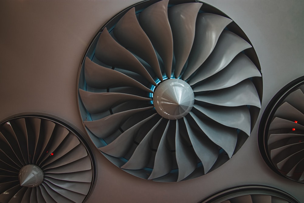 a group of metal fans mounted on a wall