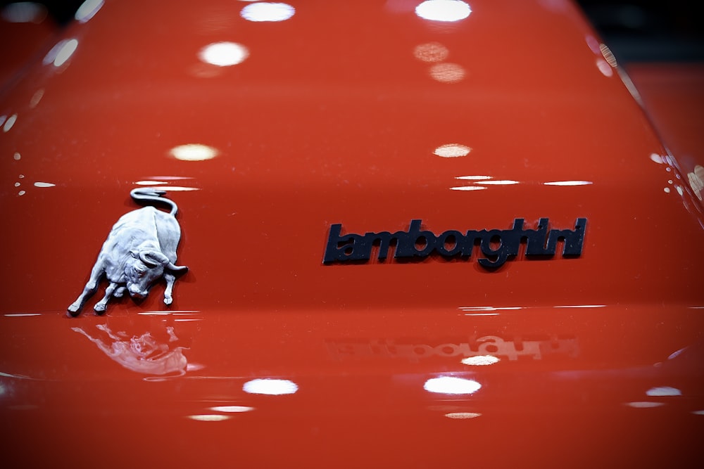 a close up of the emblem on a red car