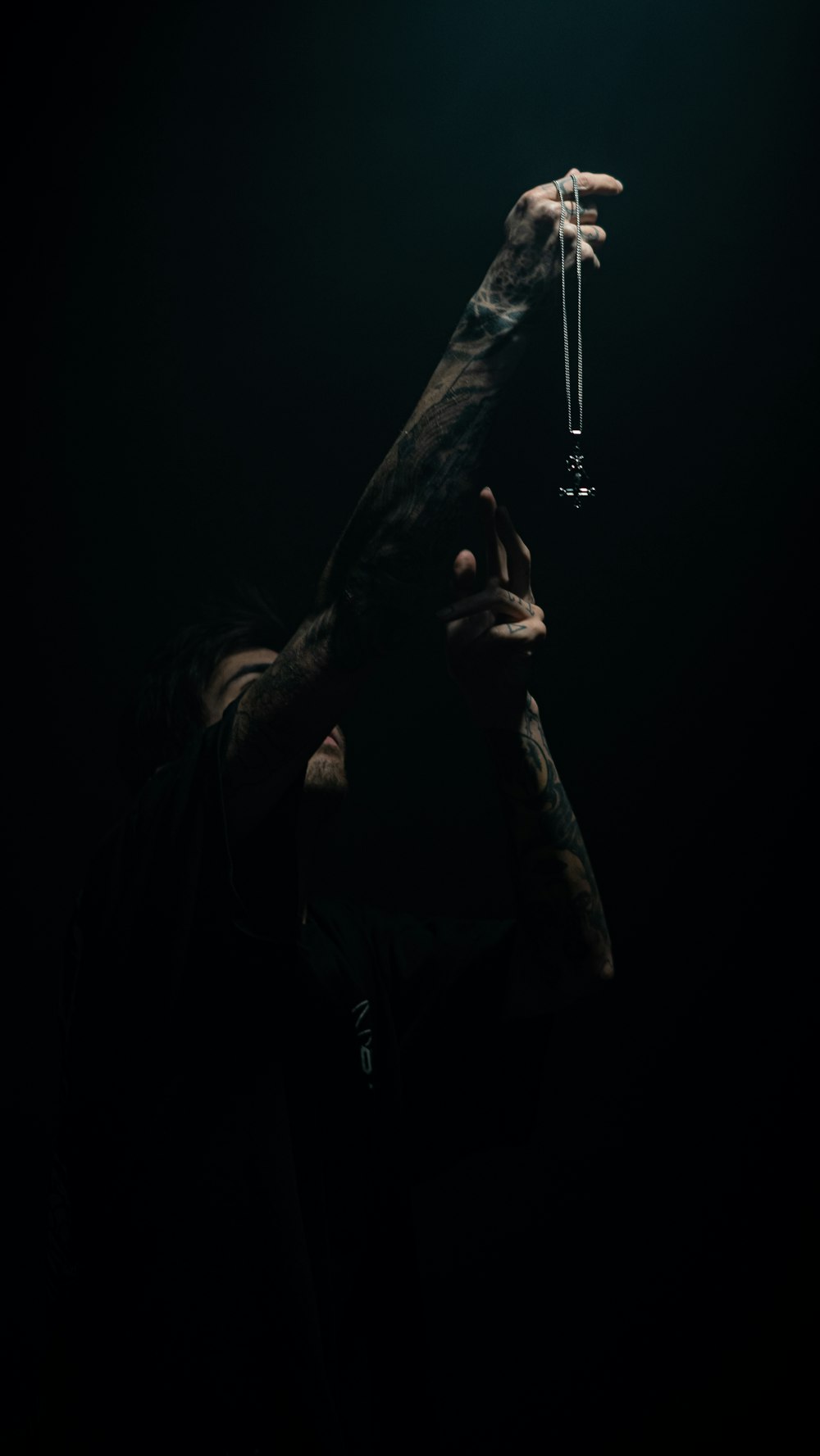 a man holding a glass in the dark