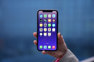a person holding an iphone in their hand
