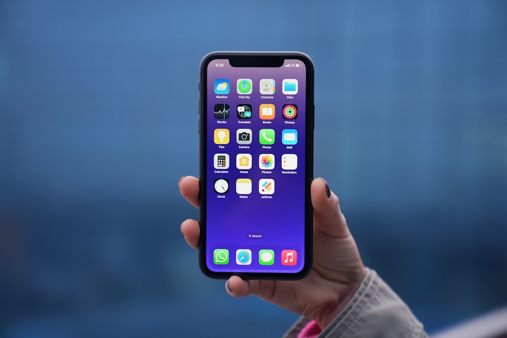 a person holding an iphone in their hand