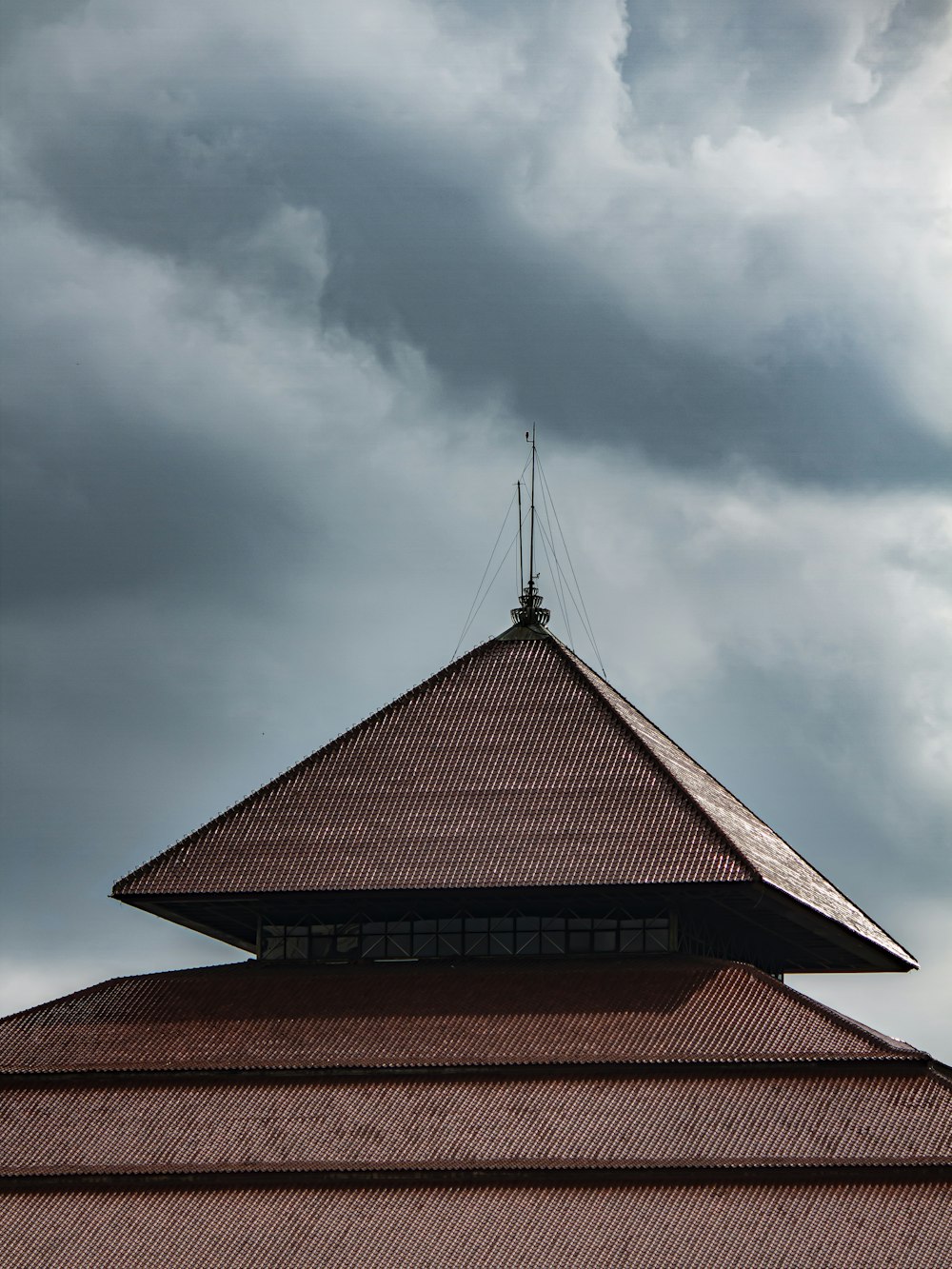 a tall building with a weather vane on top of it