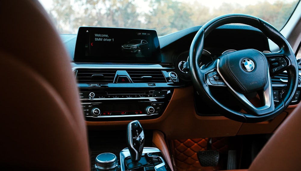 the interior of a bmw car with a dashboard and steering wheel