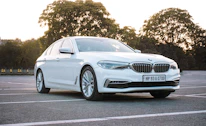 A sleek modern car ready for rental parked in a clean, organized lot.